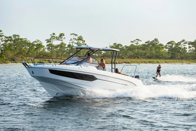 Slide: The Image of 2026 Beneteau Flyer 8 SUNdeck cruising with wakeboarder on scenic waterway. - 12