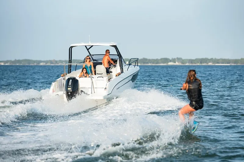 Slide: The Image of 2026 Beneteau Flyer 8 SUNdeck towing a wakeboarder on a sunny day. - 14