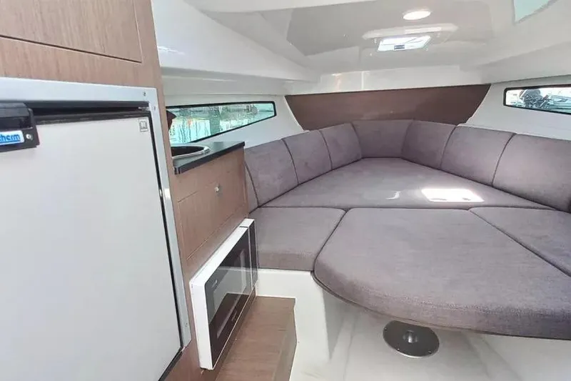 Slide: The Image of Interior of 2026 Beneteau Flyer 8 SUNdeck with cozy seating and modern amenities. - 7