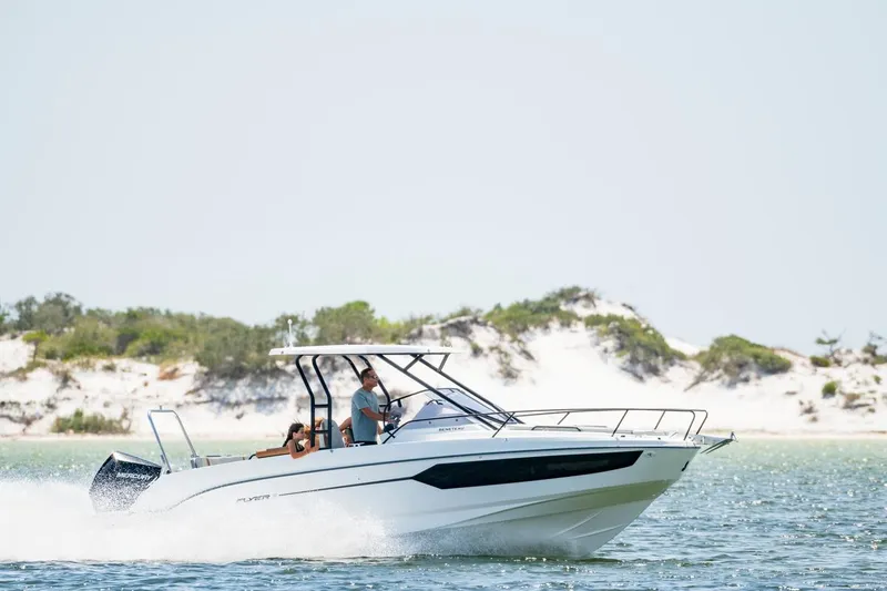 Slide: The Image of 2026 Beneteau Flyer 8 SUNdeck cruising on a sunny day near sandy shoreline. - 9
