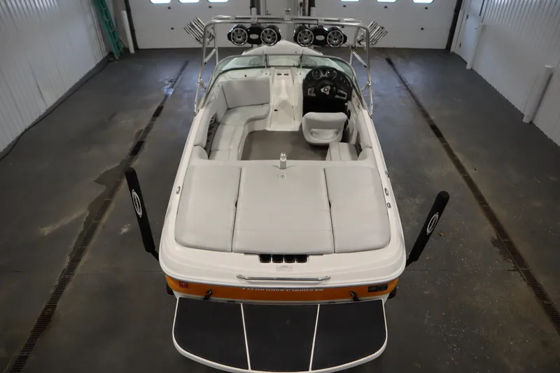 Slide: The Image of 2008 Moomba Outback V boat interior with seating and speakers in a garage. - 10