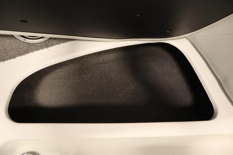 Slide: The Image of 2008 Moomba Outback V interior storage compartment with black carpet lining. - 15