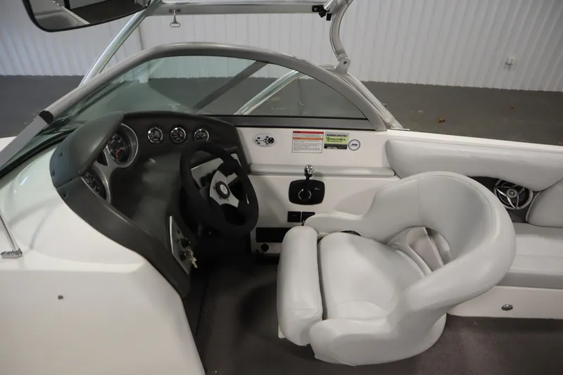 Slide: The Image of 2008 Moomba Outback V boat interior with steering wheel and white captain's chair. - 16