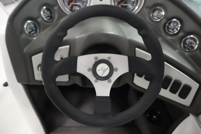 Slide: The Image of 2008 Moomba Outback V dashboard with steering wheel and gauges. - 18
