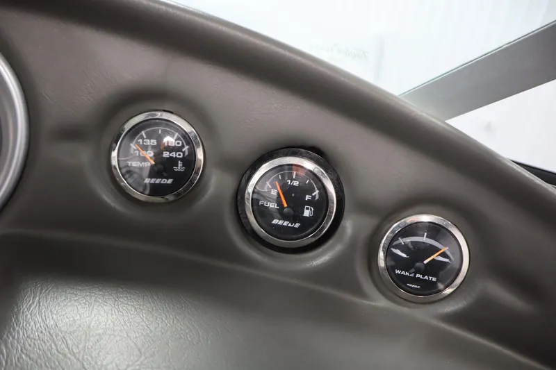 Slide: The Image of Dashboard gauges of a 2008 Moomba Outback V boat, showing temperature, fuel, and wake plate. - 21