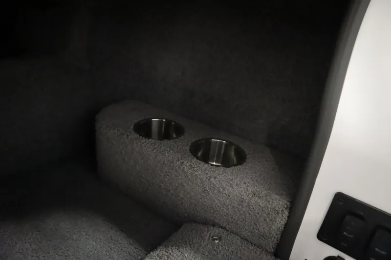 Slide: The Image of 2008 Moomba Outback V interior with dual cup holders and carpeted finish. - 27