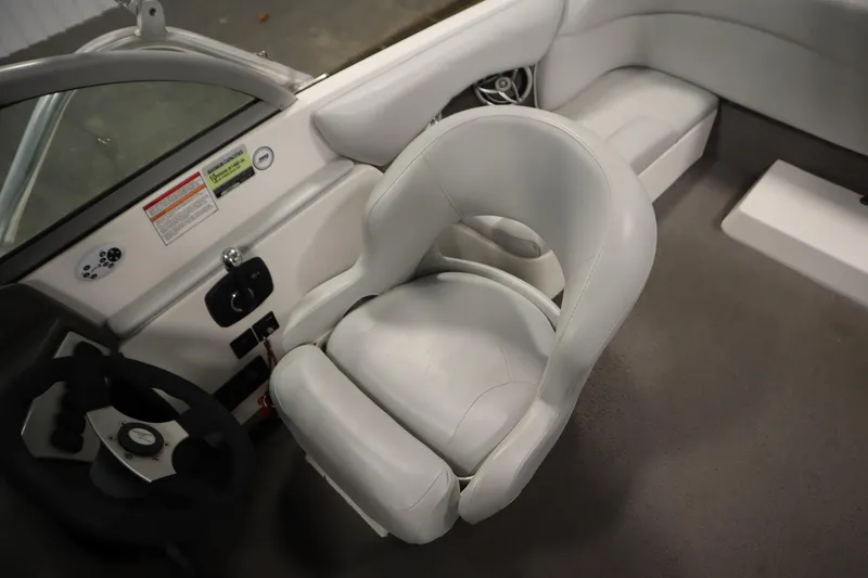 Slide: The Image of 2008 Moomba Outback V boat interior with white captain's chair and steering wheel. - 29