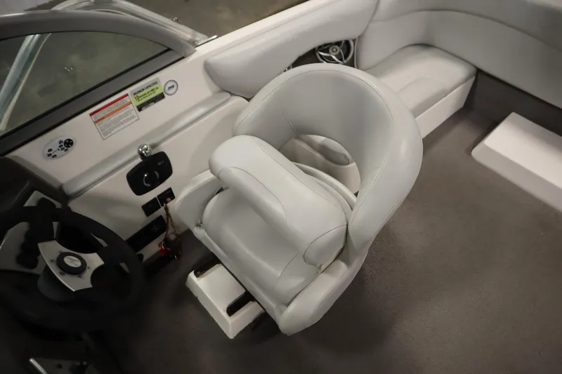 Slide: The Image of 2008 Moomba Outback V boat interior with white captain's chair and steering wheel. - 30