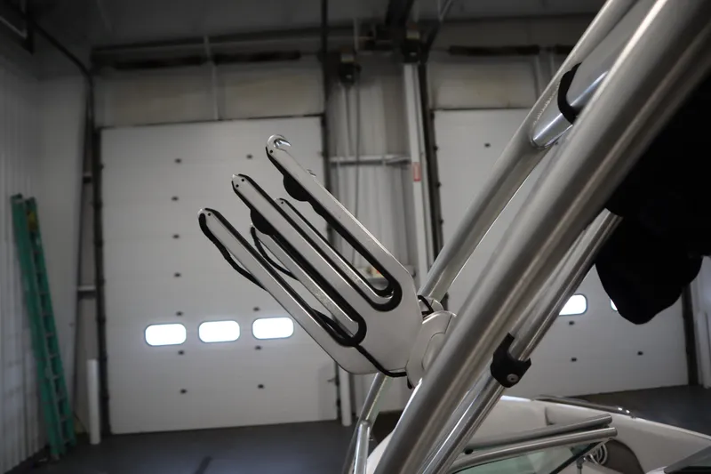 Slide: The Image of 2008 Moomba Outback V boat tower with wakeboard rack in a garage setting. - 45