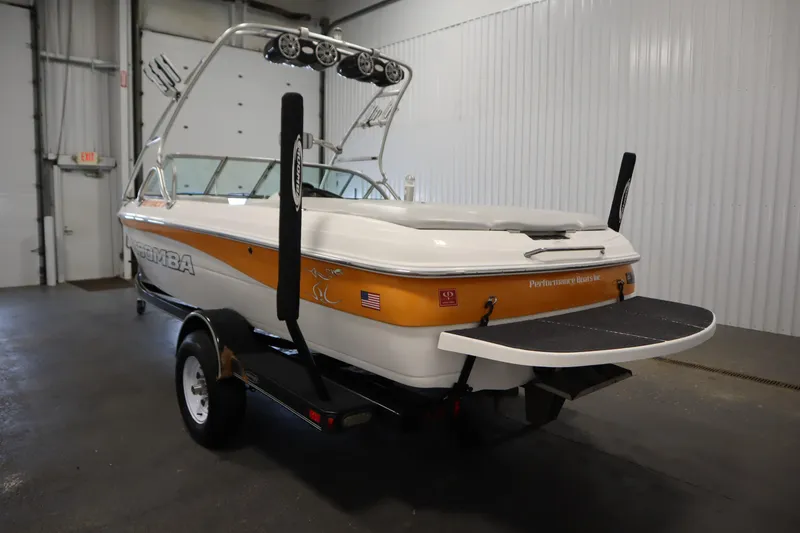 Slide: The Image of 2008 Moomba Outback V boat in a garage, featuring a sleek design and vibrant colors. - 7