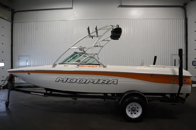 Slide: The Image of 2008 Moomba Outback V boat in a garage, side view with trailer. - 8