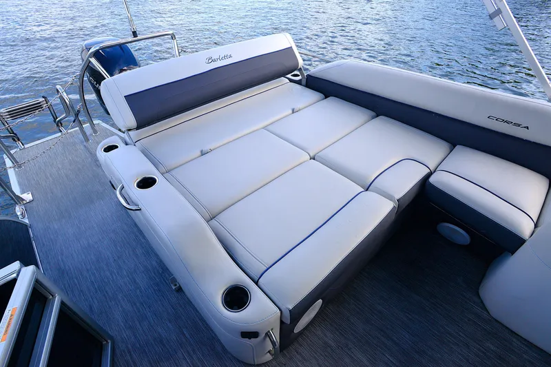 Slide: The Image of Luxurious seating on 2022 Barletta Corsa 25U pontoon boat, featuring comfortable cushions and cup holders. - 16