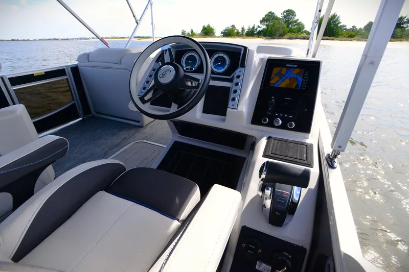 Slide: The Image of 2022 Barletta Corsa 25U boat interior with steering wheel and navigation system. - 22