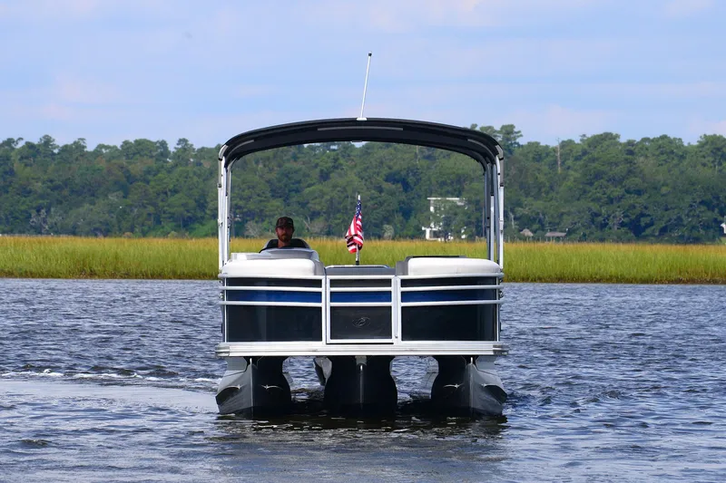 Slide: The Image of 2022 Barletta Corsa 25U pontoon boat cruising on a scenic lake. - 8