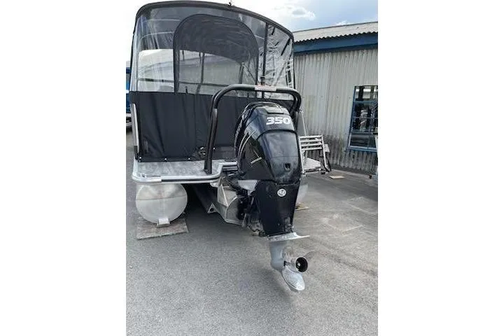 Slide: The Image of 2021 Crest Continental 250 SLS pontoon boat with 350 horsepower engine, docked outdoors. - 10