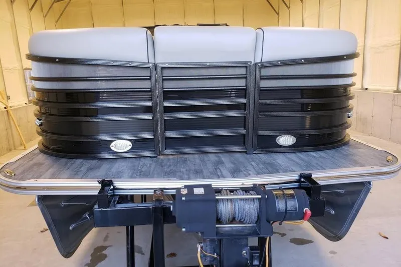 Slide: The Image of 2021 Crest Continental 250 SLS pontoon boat in a garage, showcasing sleek design and modern features. - 11