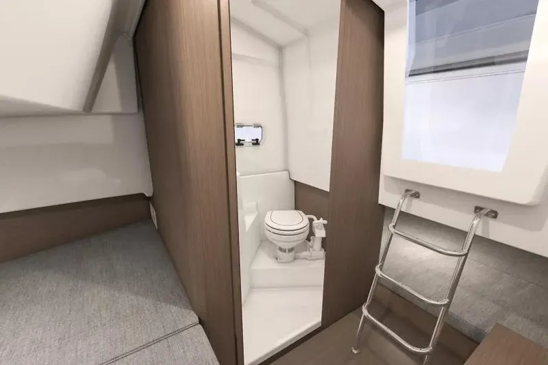 Slide: The Image of Interior of 2026 Beneteau Flyer 9 SPACEdeck, featuring compact bathroom and ladder access. - 9
