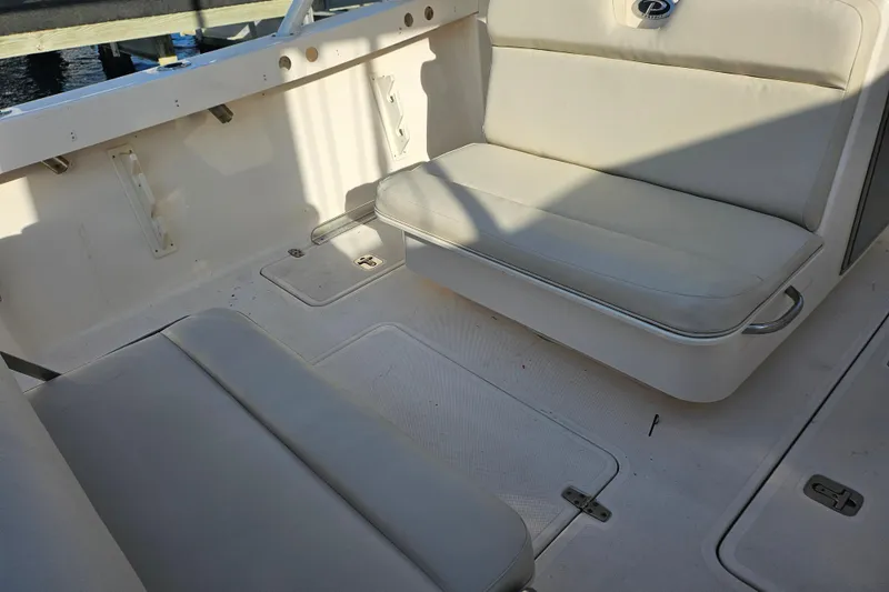 Slide: The Image of 2012 Pursuit C 310 Center Console boat interior with cushioned seating. - 17