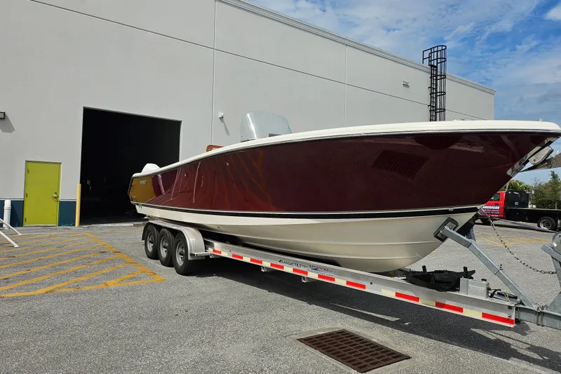 Slide: The Image of 2012 Pursuit C 310 Center Console boat on trailer outside warehouse. - 29