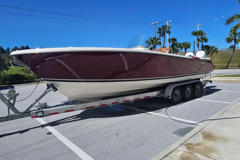 Slide: The Image of 2012 Pursuit C 310 Center Console boat on trailer in sunny parking lot. - 30
