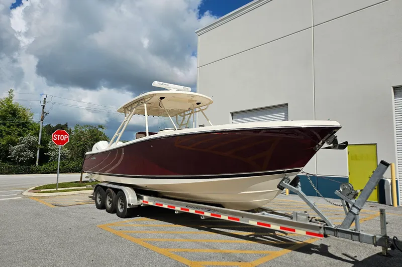 Slide: The Image of 2012 Pursuit C 310 Center Console boat on trailer near stop sign. - 31