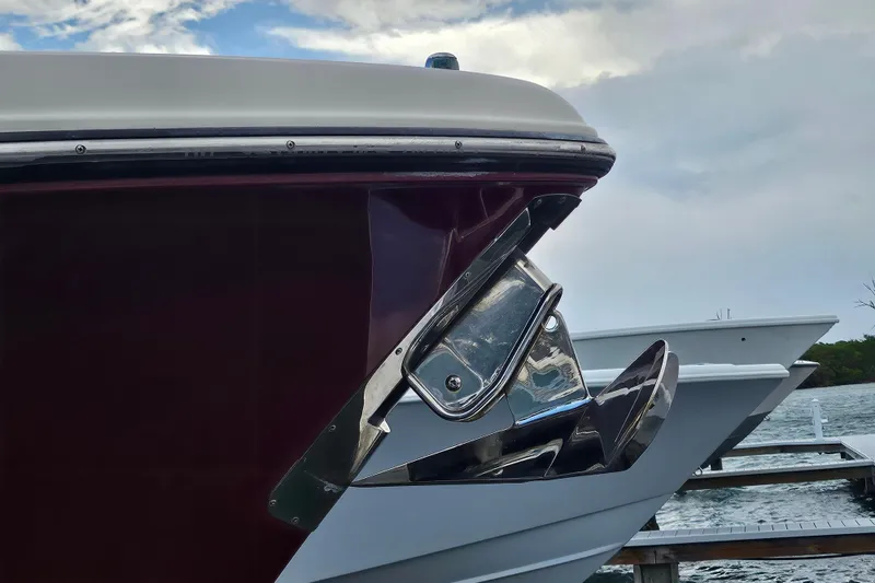 Slide: The Image of 2012 Pursuit C 310 Center Console boat at dock, featuring sleek design and chrome details. - 6