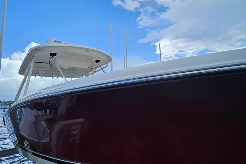 Slide: The Image of 2012 Pursuit C 310 Center Console boat under blue sky at marina. - 7
