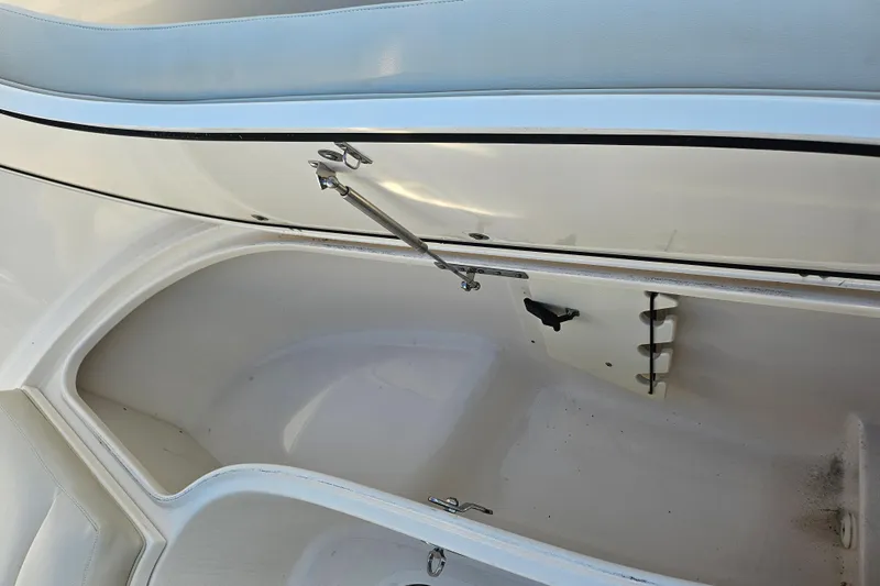 Slide: The Image of 2012 Pursuit C 310 Center Console storage compartment with open hatch and clean interior. - 9