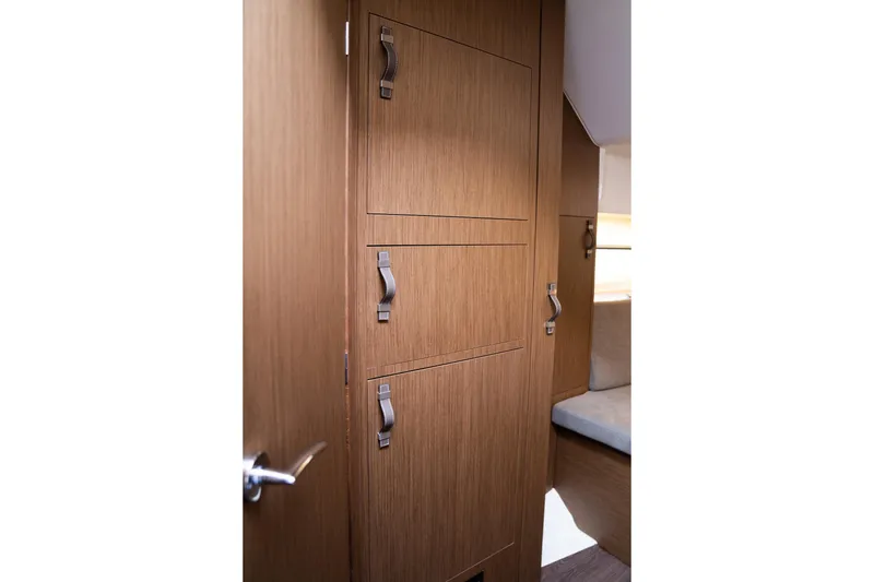Slide: The Image of Interior view of 2026 Beneteau Flyer 10 Sport Top, featuring wooden cabinetry and modern design. - 12