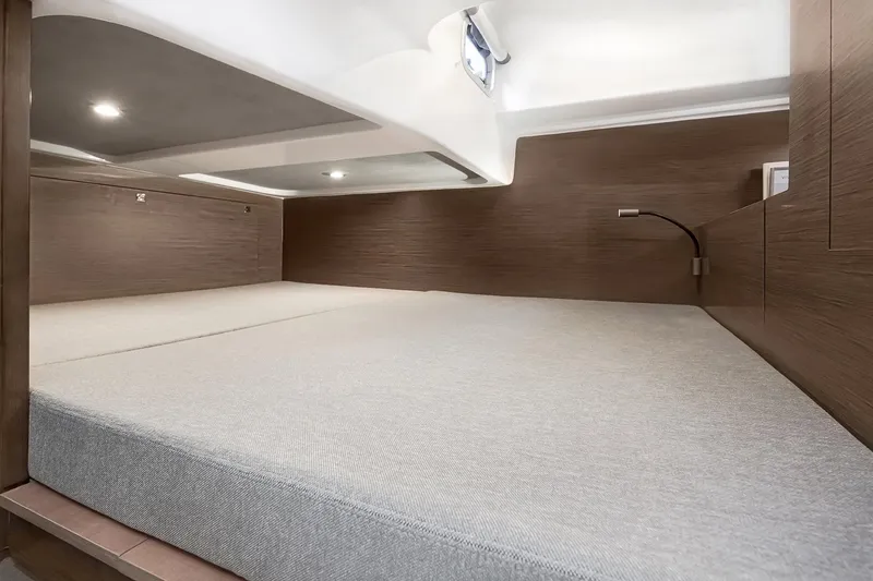 Slide: The Image of 2026 Beneteau Flyer 10 Sport Top cabin interior with modern wood finish and cozy bedding. - 6