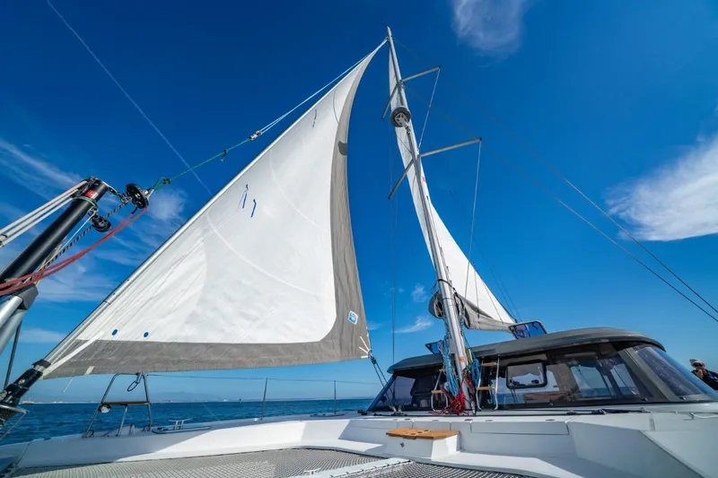 Slide: The Image of Sailing catamaran Nautitech 40 Open 2020 with sails up against clear blue sky. - 14