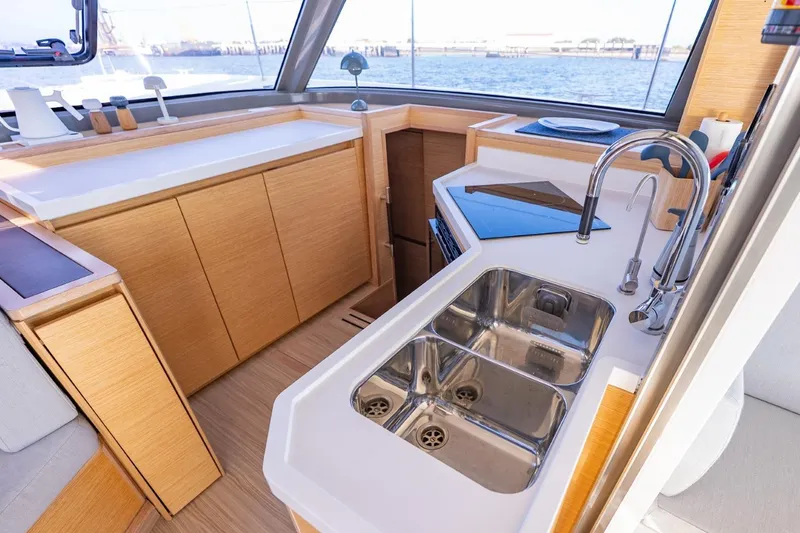 Slide: The Image of Modern kitchen area on a 2020 Nautitech 40 Open catamaran with dual sinks and sleek design. - 25