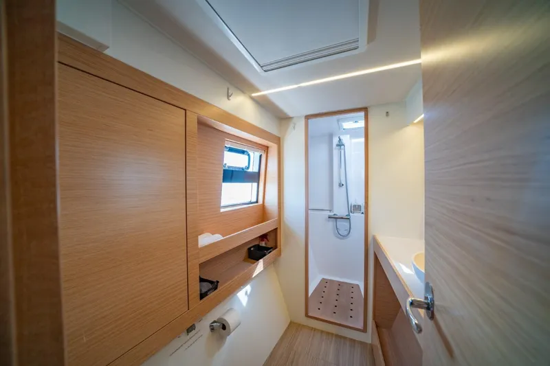 Slide: The Image of Modern bathroom interior of 2020 Nautitech 40 Open catamaran, featuring wood accents and shower. - 29