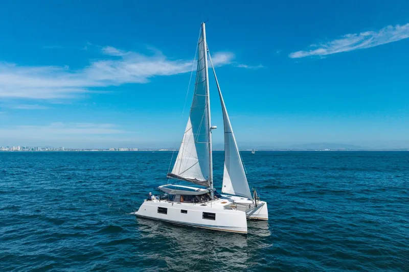 Slide: The Image of 2020 Nautitech 40 Open catamaran sailing on a clear blue ocean. - 3