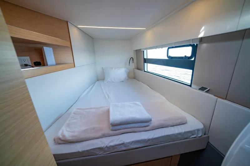 Slide: The Image of Cozy cabin interior of 2020 Nautitech 40 Open catamaran with bed and window view. - 32