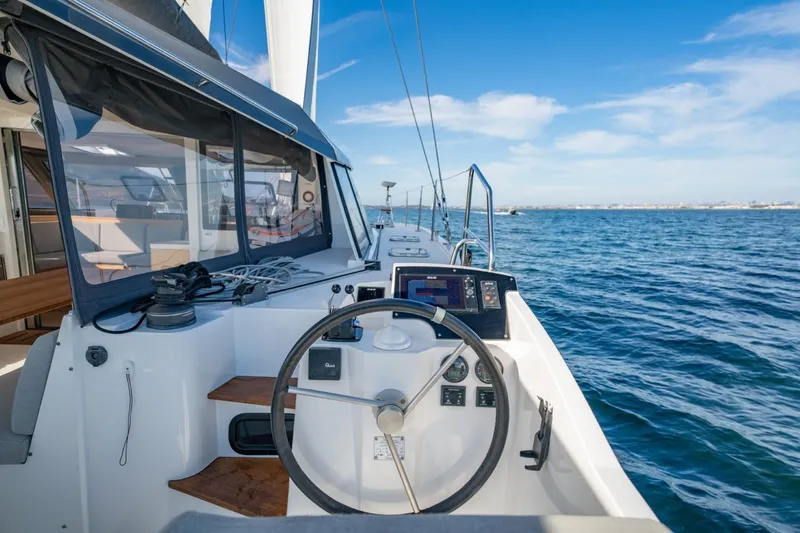 Slide: The Image of 2020 Nautitech 40 Open catamaran helm with ocean view, featuring modern navigation equipment. - 6