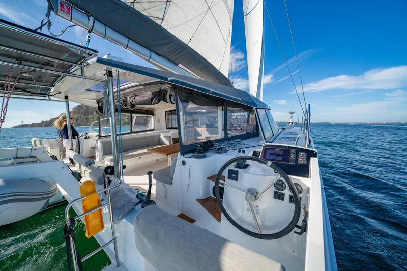 Slide: The Image of 2020 Nautitech 40 Open catamaran sailing on open water, featuring modern cockpit and helm. - 7