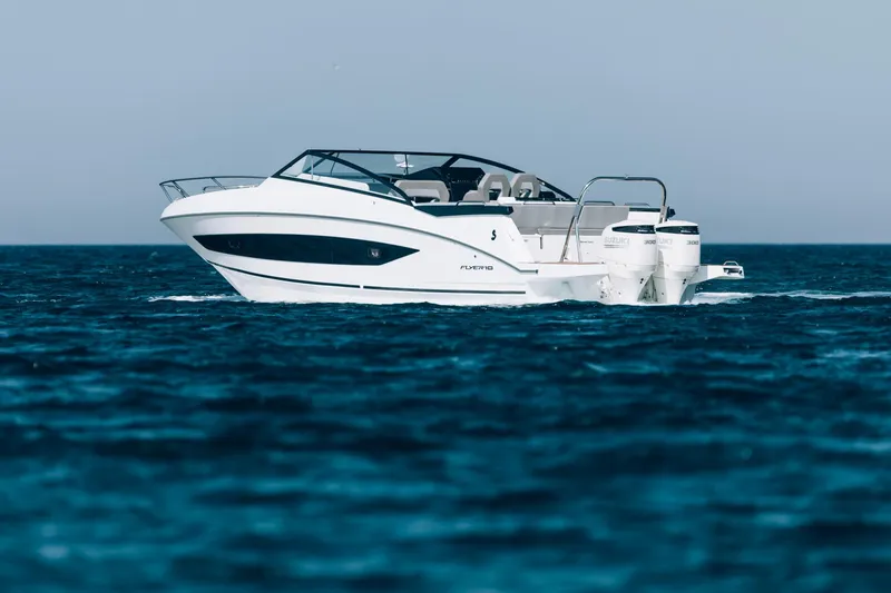 Slide: The Image of 2024 Beneteau Flyer 10 cruising on open water, side view. - 3