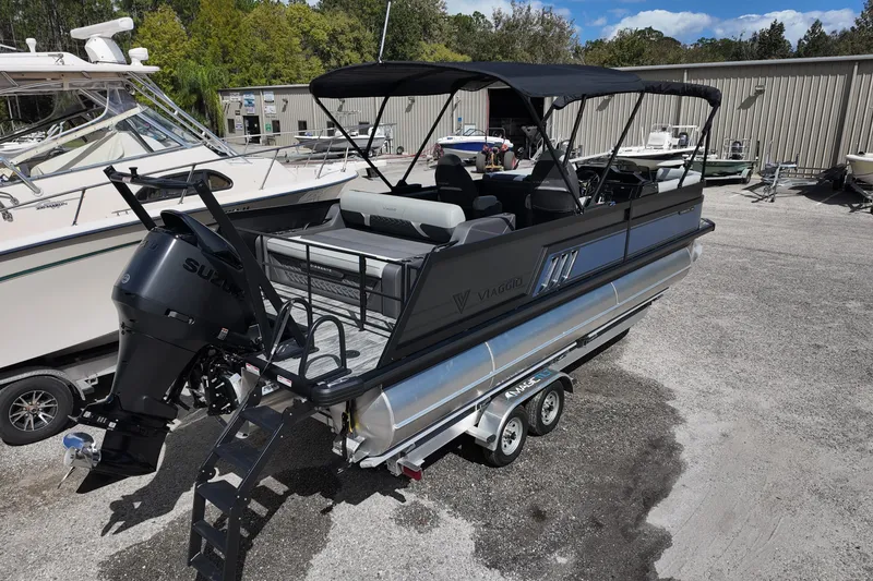 Slide: The Image of 2026 Viaggio Diamante 24S pontoon boat with Suzuki outboard motor on trailer. - 6