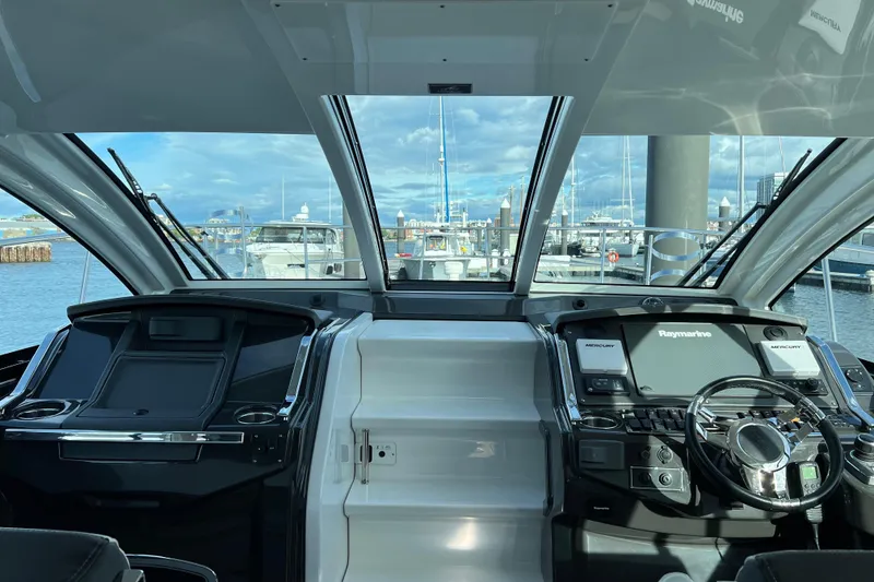 Slide: The Image of Interior view of 2018 Monterey 360 Sport Coupe yacht cockpit with marina backdrop. - 10