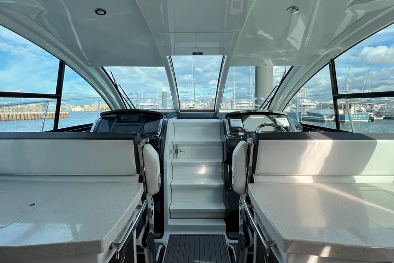 Slide: The Image of Interior view of a 2018 Monterey 360 Sport Coupe yacht with marina backdrop. - 11