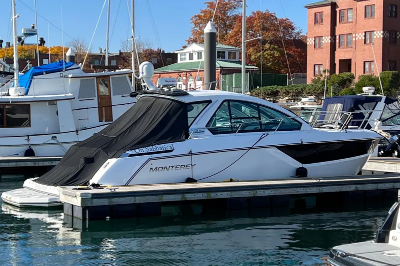 Slide: The Image of 2018 Monterey 360 Sport Coupe docked at marina with autumn foliage background. - 4