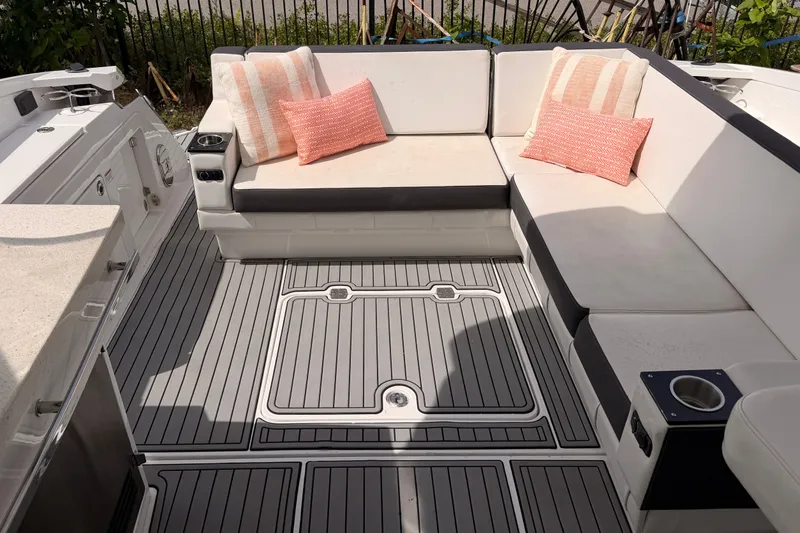 Slide: The Image of Luxurious seating area on a 2018 Monterey 360 Sport Coupe boat with cushions and sleek flooring. - 9