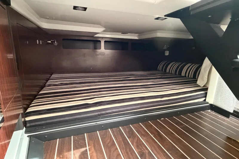 Slide: The Image of Luxurious cabin interior of 2018 Monterey 360 Sport Coupe with striped bedding. - 34