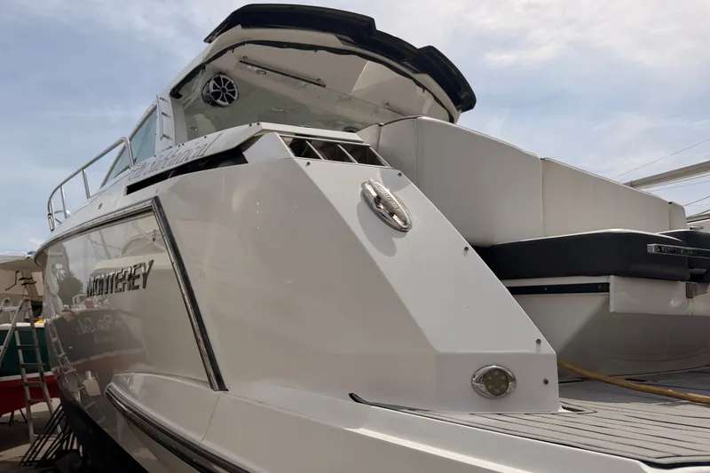 Slide: The Image of 2018 Monterey 360 Sport Coupe boat, sleek design, docked under a clear sky. - 5