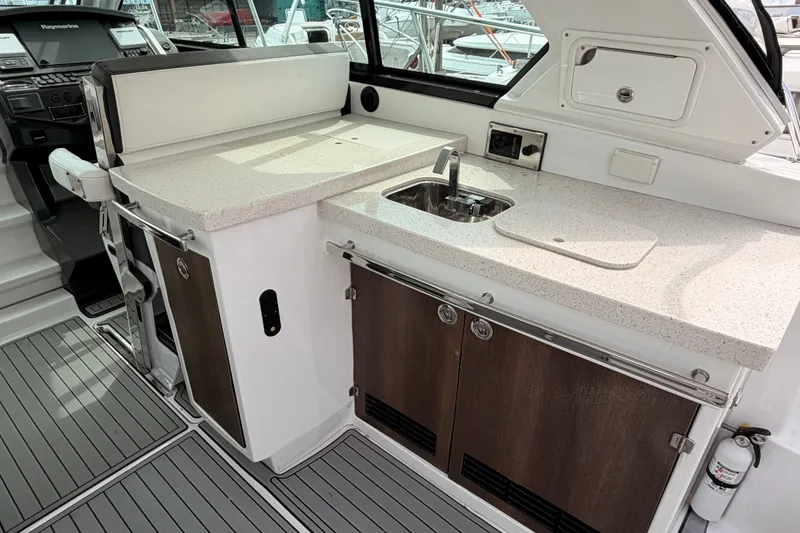 Slide: The Image of 2018 Monterey 360 Sport Coupe yacht interior with sleek kitchenette and modern amenities. - 19