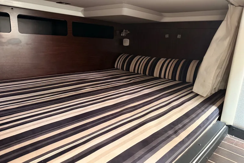 Slide: The Image of Interior cabin of 2018 Monterey 360 Sport Coupe with striped bedding. - 33
