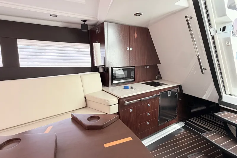 Slide: The Image of Interior of 2018 Monterey 360 Sport Coupe with modern kitchen and seating area. - 31