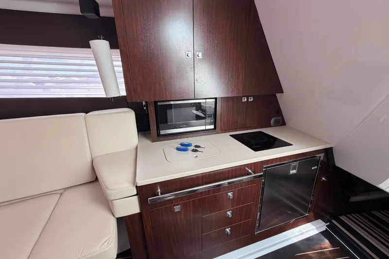 Slide: The Image of Luxurious 2018 Monterey 360 Sport Coupe yacht interior with modern kitchenette and seating. - 28
