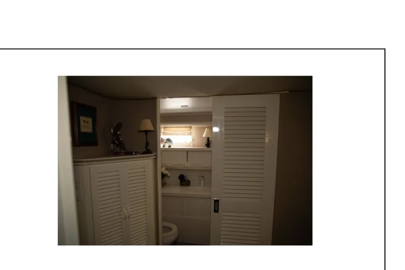 Slide: The Image of 1977 Hatteras 58 Yacht Fisherman bedroom with cozy bed and soft lighting. - 12